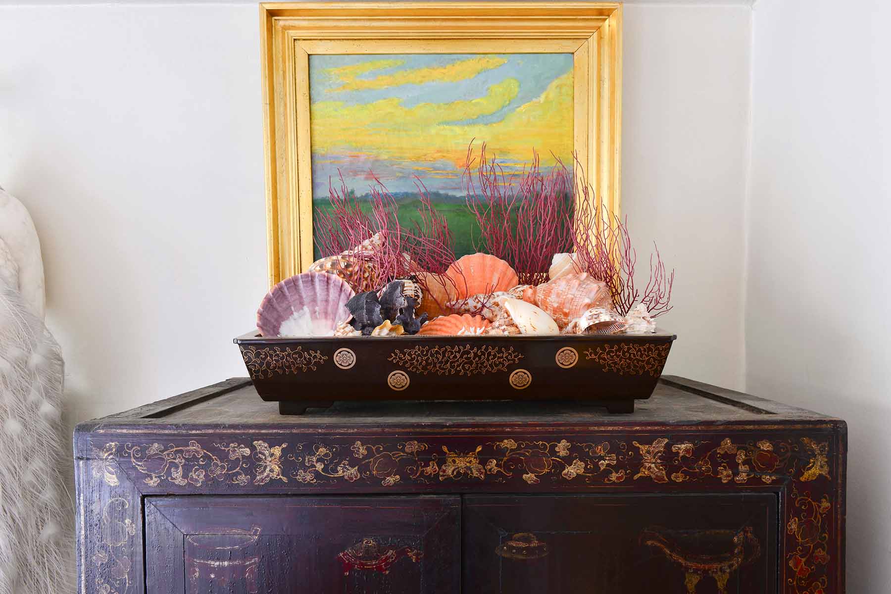 Vintage cabinet with asian bowl of shells and seascape painting