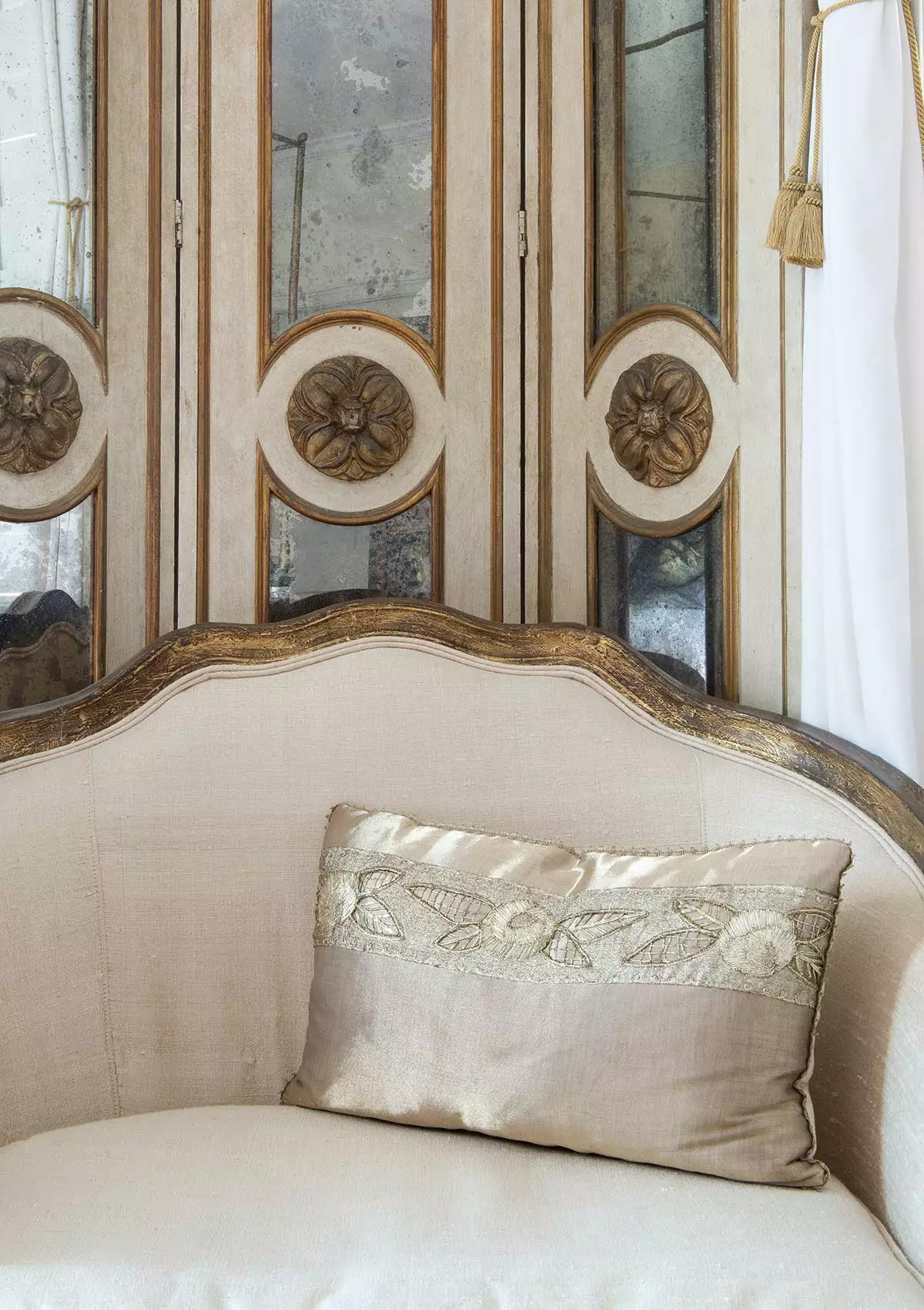 Ivory silk loveseat with mirrored gold screen panel